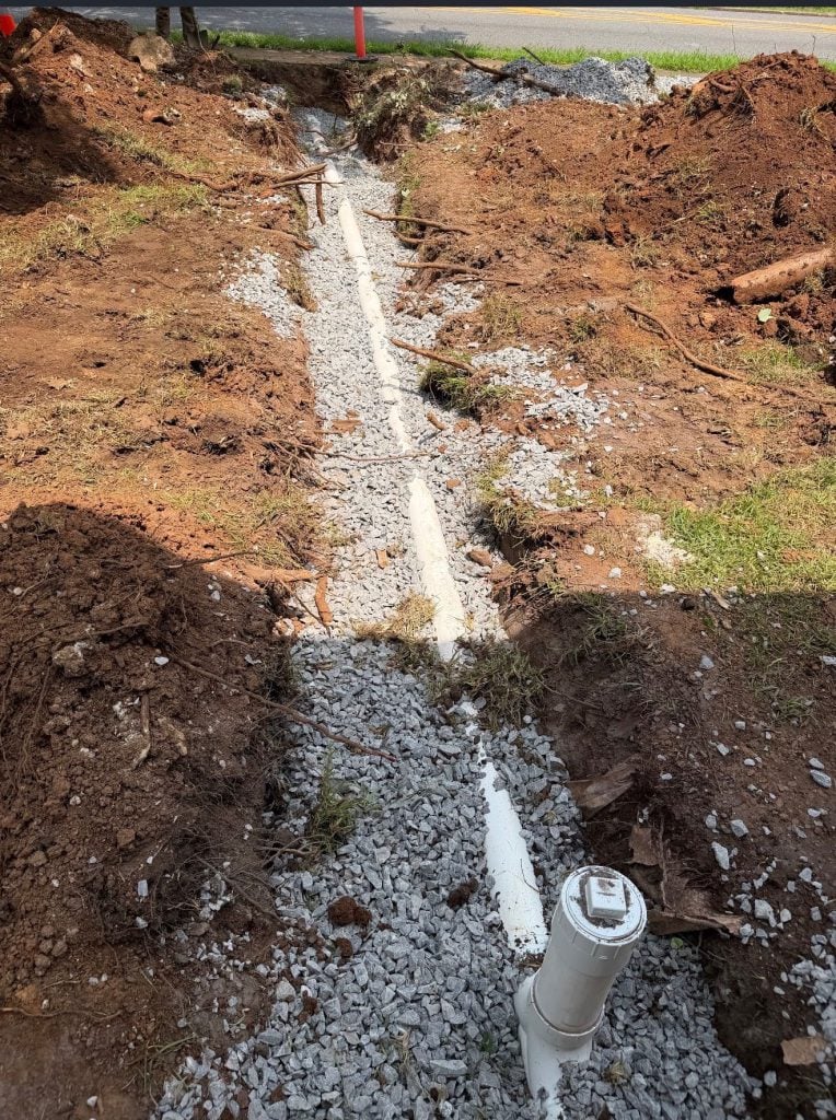 New sewer line bedded in gravel with a cleanout at the curb